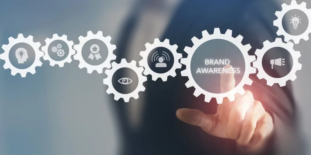 Brand awareness concept depicting virtual gears, symbolizing aspects of awareness. Hands interact w/ the gears.