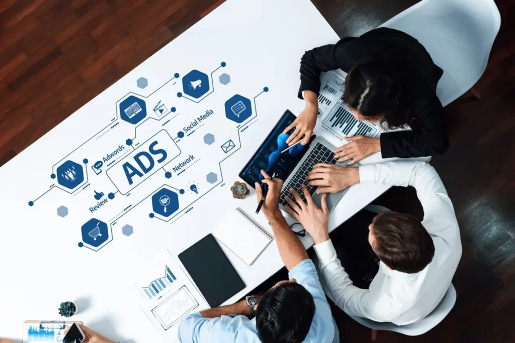 A layout on a meeting table displaying the breakdown of an ad strategy.
