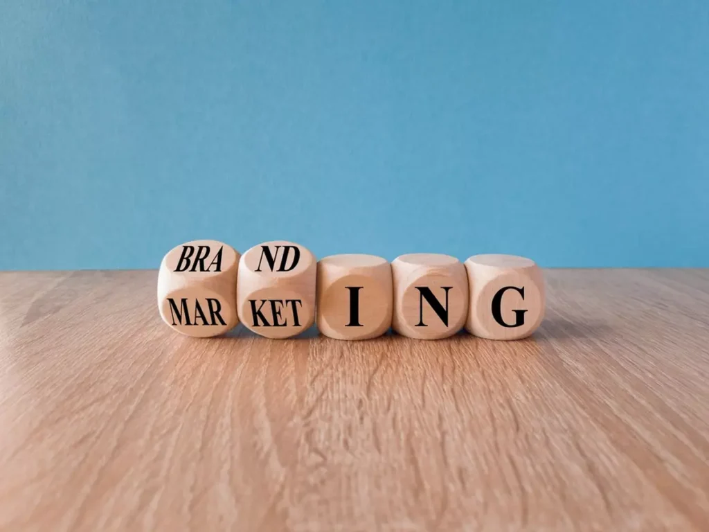 Wooden cubes that read out the letters 'BRAND MARKETING' that symbolize the concept of branding.