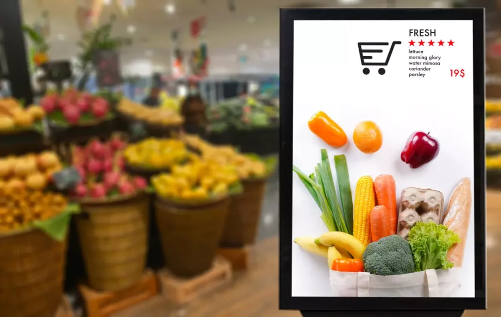 Digital signage in a grocery store’s produce section.