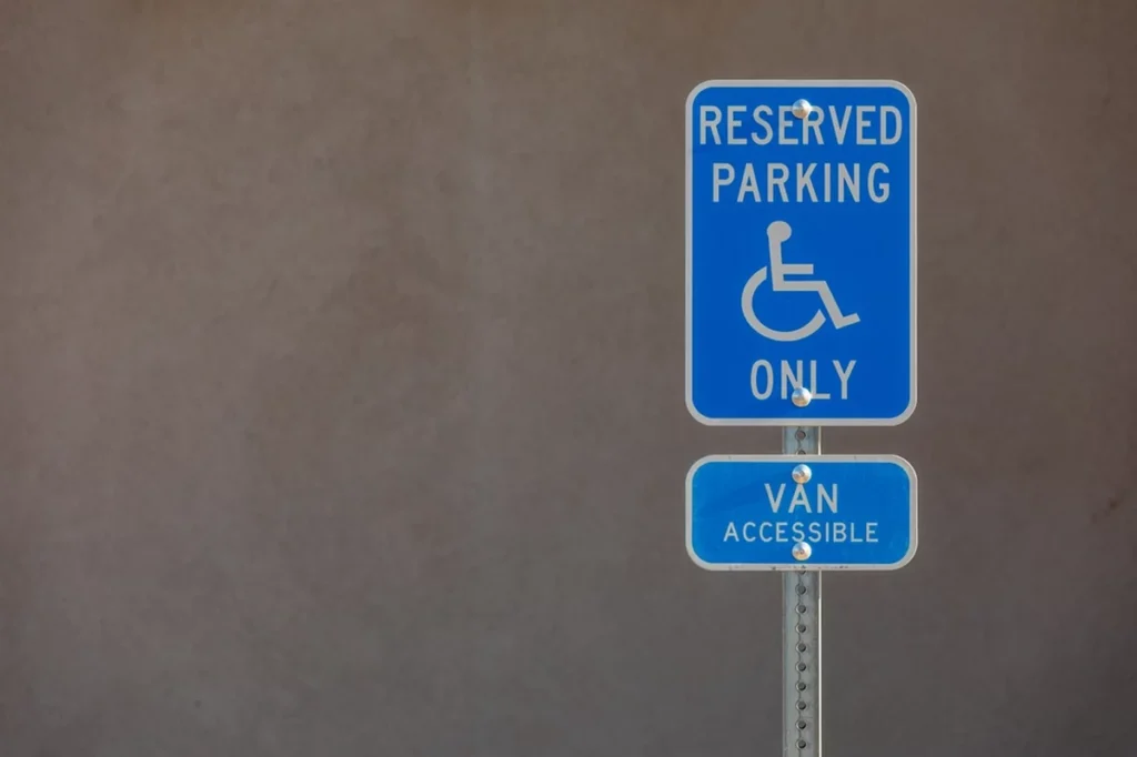 Sign 'Handicapped Reserved Parking Only; Van Accessible' in a Parking Lot.