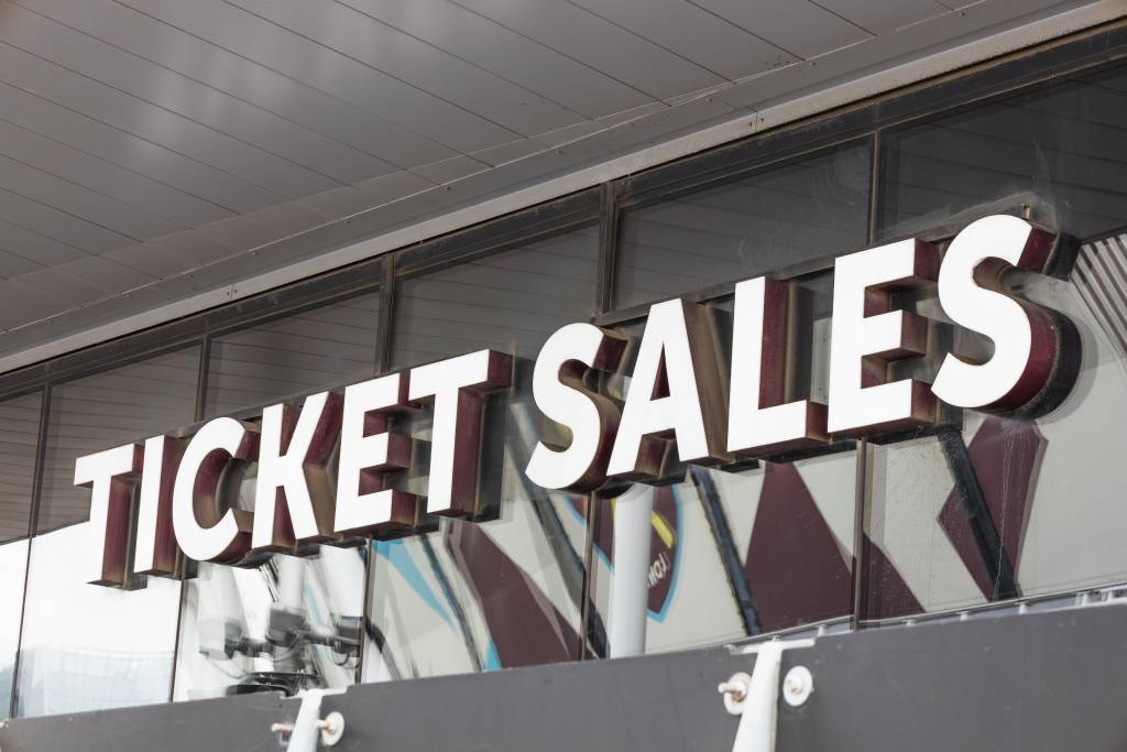Ticket Sales sign at stadium box office entrance.