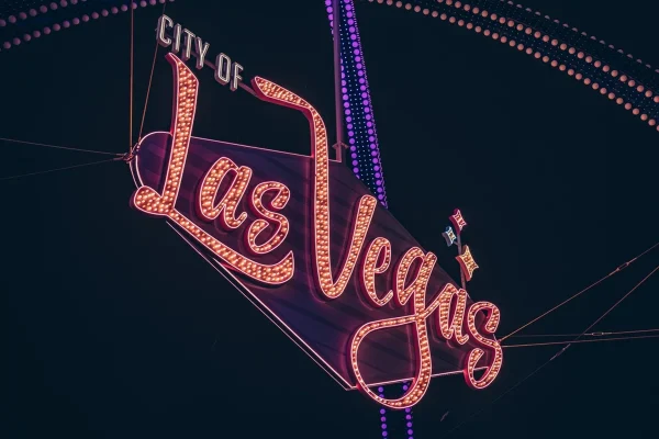 A purple-neon sign that reads CITY OF LAS VEGAS.