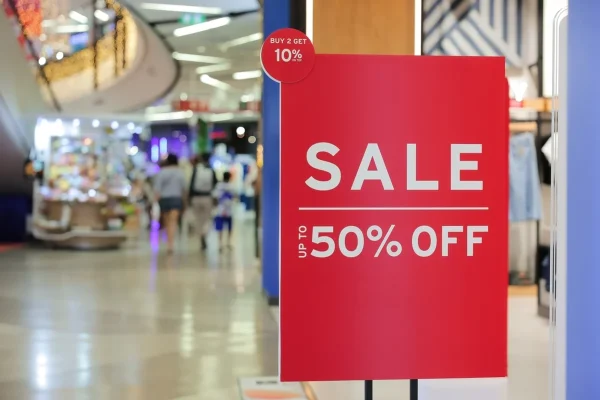 Signs announcing the start of sales in the store, sale signs in front of the store, discounts up to 50 percent.